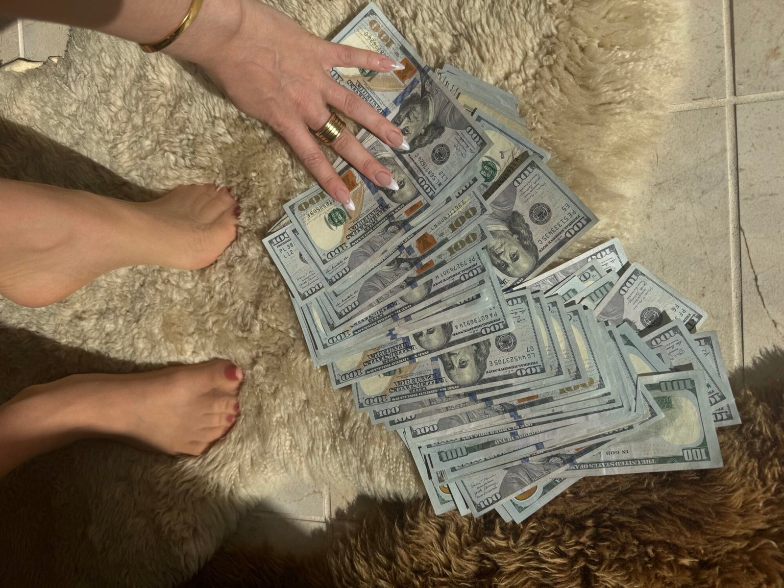 Mistress Blunt spreads out a cashdrop on sheepskin in front of her stockinged feet