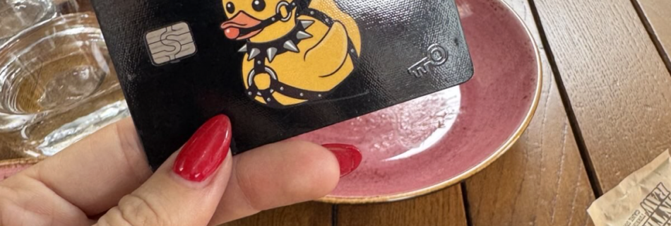 photo of mistress blunt with red nails holding her finsub's credit card as part of an FLR