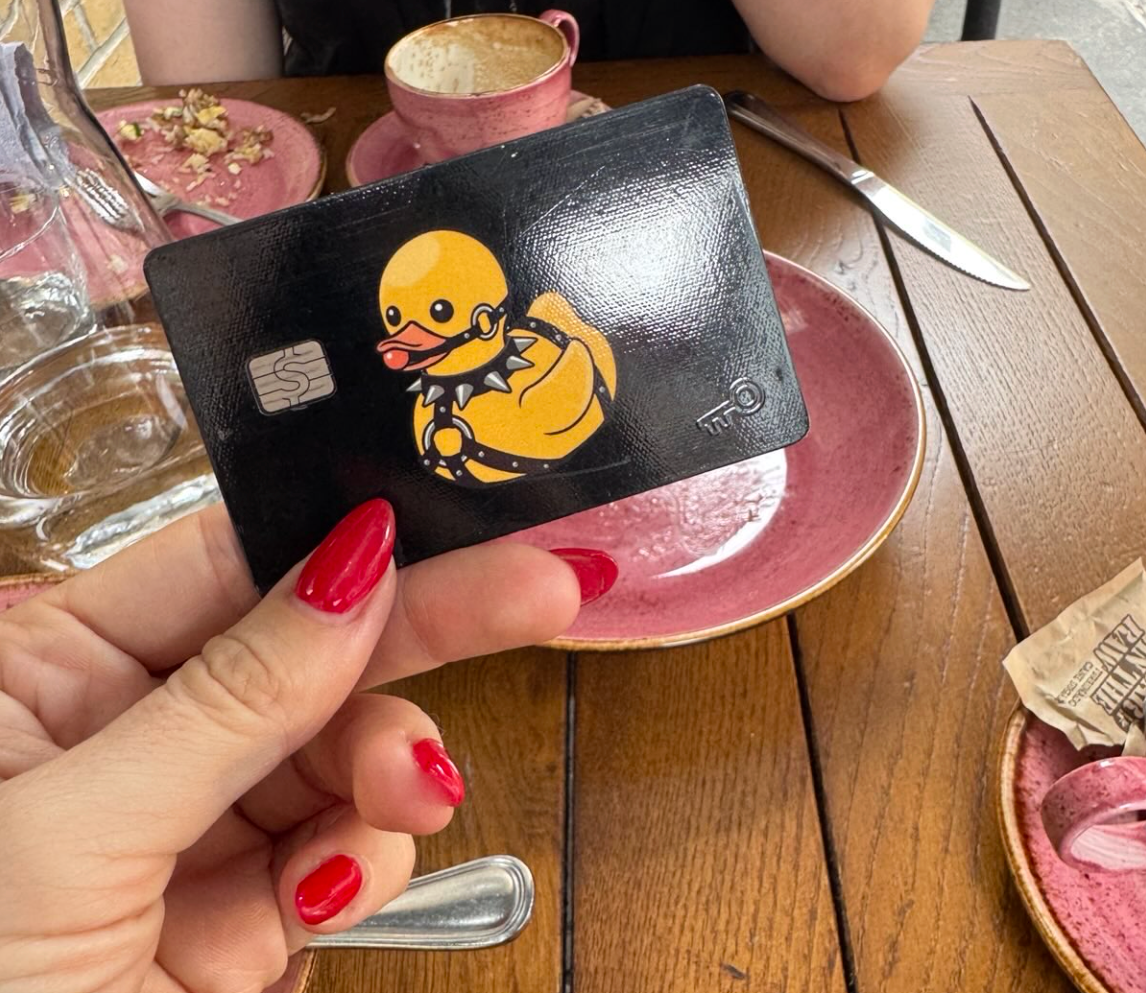 photo of mistress blunt with red nails holding her finsub's credit card as part of an FLR